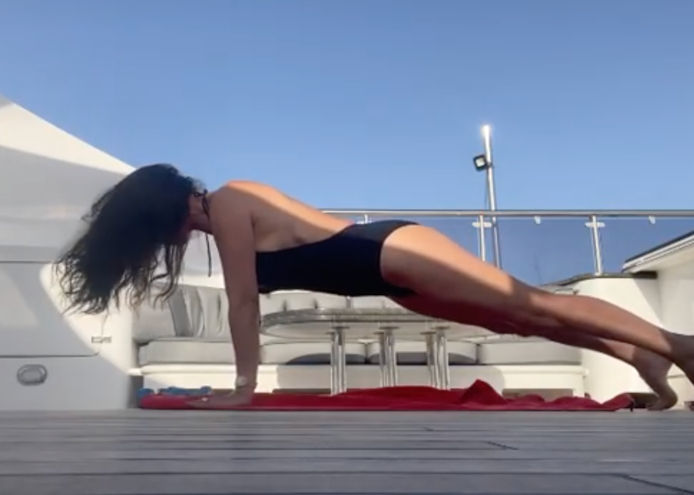 Catherine Zeta-Jones, 51, Shows Side-Boob In Backless Swimsuit While Doing Yoga On A Boat